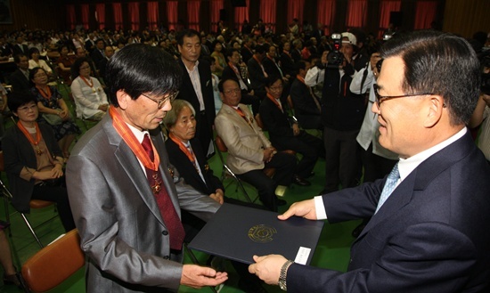 NSP통신-고영진교육감이 퇴직교원에게 훈·포장을 전수하고 있다.<사진제공=경남도교육청>