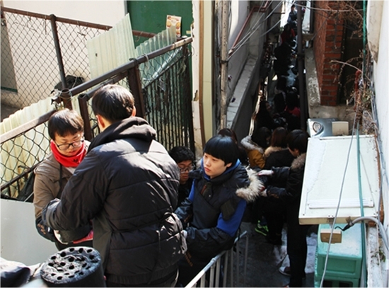 NSP통신-유디치과 관계자들과 사단법인 따뜻한 한반도 사랑의 연탄 나눔 운동본부 자원봉사자들이 착한 연탄을 배달하고 있다. (유디)