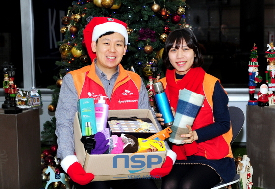 NSP통신-SK건설 임직원들이 희망메이커 후원가정에 전달할 크리스마스 선물키트를 들고 환하게 웃고 있다.