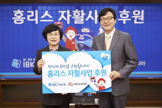 NSP통신-후원물품 전달식을 마치고 권선주 기업은행장(왼쪽)과 안기성 빅이슈코리아 대표가 기념촬영을 하고 있는 모습.(사진제공=IBK기업은행)