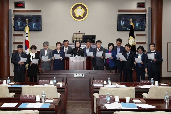 NSP통신-광명시의회 의원들이 서울 민자고속도로 지상화 건설 반대를 위한 결의문을 낭독하고 있다. (광명시의회)