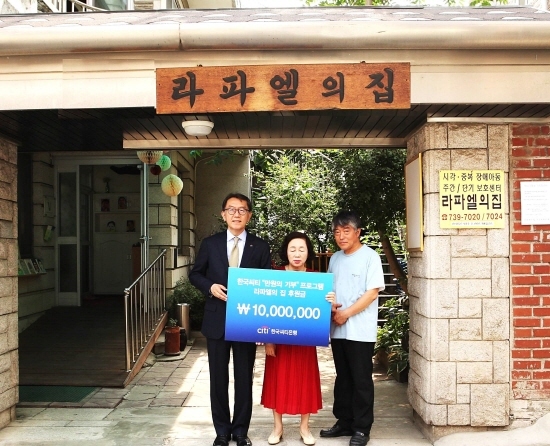 NSP통신-한국씨티은행 박진회 은행장(좌측 첫번째)이 라파엘의 집 오옥자 시설장(가운데)에게 후원금 1천만원을 전달하고 있다.