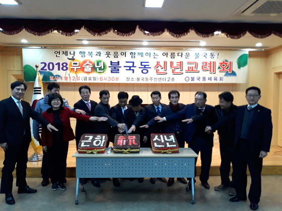 NSP통신-경주시 불국동 체육회와 내빈들이 2018년 신년교례회에서 기념떡 전달식을 가지고 있다.