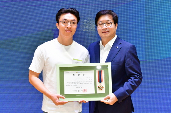NSP통신-4일 시청 대강당에서 염태영 수원시장(오른쪽)이 러시아 여행 중 화재현장에서 7명 대피를 도운 류광현씨에게 선행시민 표창을 수여한 후 기념촬영을 하고 있다. (수원시)