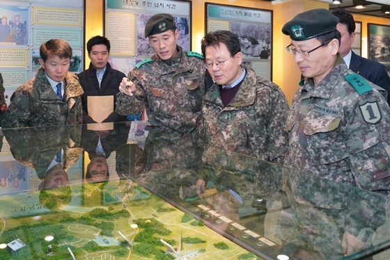 NSP통신-김광수 농협금융회장(왼쪽 4번째)이 육군제1보병사단을 찾아 부대 현황 설명을 듣고 있다. (농협금융지주)