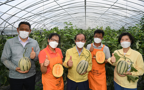 NSP통신-이승율 청도군수가 캔털루프멜론의 첫 출하를 앞둔 하늘담은정원을 방문해 농주들과 함께 멜론을 들고 포즈를 취했다 (청도군)