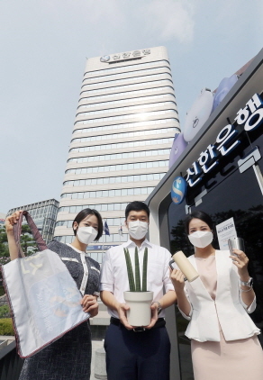 NSP통신-12일 서울 중구에 위치한 신한은행 본점에서 신한은행 직원들이 은행에서 사용했던 각종 폐현수막을 새활용한 장바구니와 공기정화식물인 스투키, 대표적 다회용기인 텀블러를 들고 신한 ESG 실천 빌딩 선언에 동참하고 있다. (신한은행)