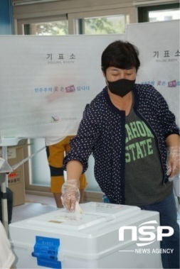 NSP통신-용인이동초등학교 제5투표소에서 한 유권자가 기표한 투표용지를 투표함에 넣고 있다. (김병관 기자)