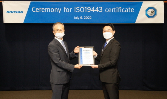 NSP통신-인증서 수여식에서 강홍규 두산에너빌리티 원자력BG 상무(왼쪽)와 서정욱 TUV SUD Korea 대표가 기념촬영을 하고 있다. (두산에너빌리티)