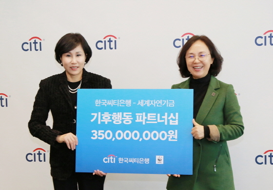 지난 8일 협약식에서 유명순 한국씨티은행장(왼쪽)이 홍윤희 WWF-Korea 사무총장(오른쪽)에게 후원금을 전달하고 있다. (한국씨티은행)