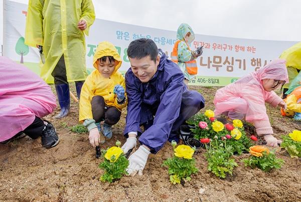 NSP통신-김태우 서울 강서구청장(정면 왼쪽 두 번째)이 제78회 식목일 나무심기 행사에서 아이와 함께 꽃을 심고 있다. (사진 = 강서)