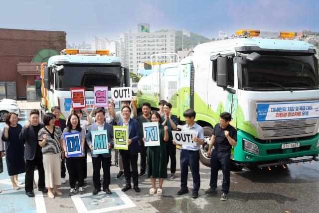 NSP통신-박승원 시장(앞 줄 오른쪽 다섯번째)과 시 관계자들이 미세먼지 저감과 폭염 대응을 위한 청소차와 살수차 추가 도입 운용에 앞서 미세먼지 OUT·폭염 OUT 퍼포먼스 가운데 기념촬영을 하고 있다. (사진 = 광명시)