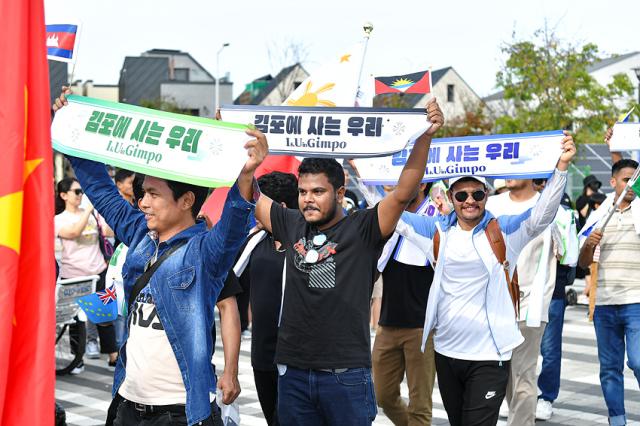 NSP통신-지난달 24일 김포에서 열린 세계인 큰잔치에서 김포거주 이주민들이 김포에 사는 우리 슬로건을 들고 행진하고 있는 모습. (사진 = 김포시)