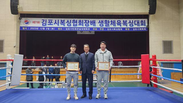 NSP통신-김포시체육회 임청수 회장이 경기에서 우승을 차지한 선수에게 상장을 수여하고 기념사진 촬영을 하고 있는 모습. (사진 = 김포시복싱협회)