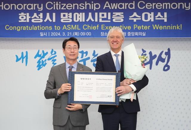 NSP통신-21일 정명근 화성시장(왼쪽)이 피터 베닝크 ASML CEO에게 명예시민증을 수여하고 기념촬영을 하고 있다. (사진 = 화성시)