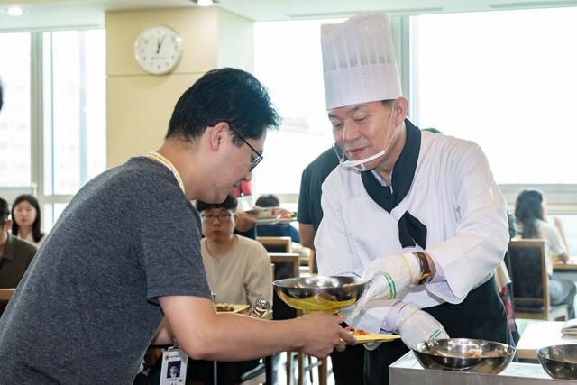 NSP통신-15일 이재준 수원시장이 직원들에게 삼계탕을 배식하고 있다. (사진 = 수원시)