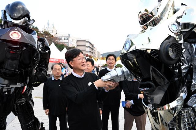 NSP통신-2024 안산사이언스밸리(ASV) 과학축제에서 이민근 안산시장이 로봇과 악수를 나누고 있다. (사진 = 안산시)