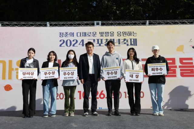 NSP통신-2024 군포 청년축제 행사에서 하은호 군포시장(가운데)이 퀴즈 이벤트 청플 골든벨 수상 청년들과 기념촬영을 하고 있다. (사진 = 군포시)