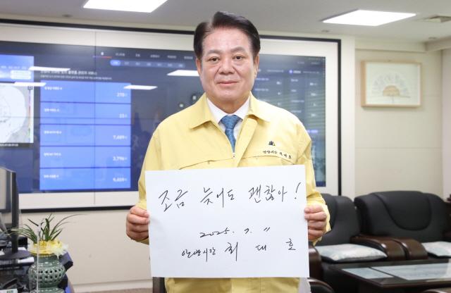 NSP통신-최대호 안양시장이 11일 오전 집무실에서 자필로 작성한 조금 늦어도 괜찮아! 문구를 들고 폭염 속 일하는 이동노동자의 안전 캠페인에 동참하고 있다. (사진 = 안양시)