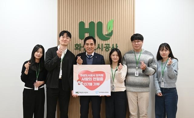 NSP통신-한병홍 화성도시공사 사장(왼쪽 세번째)과 임직원들이 헌혈증 기부 손팻말을 들고 기념촬영을 하고 있다. (사진 = 화성도시공사)