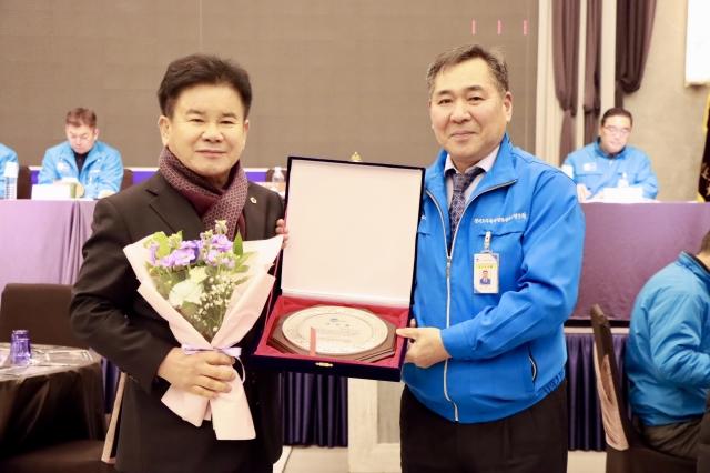 NSP통신-문병근 경기도의원(왼쪽)이 23일 2025년도 대의원 총회 및 송년의 밤 행사에서 조합으로부터 감사패를 받았다. 사진은 기념촬영 모습. (사진 = 경기도의회)