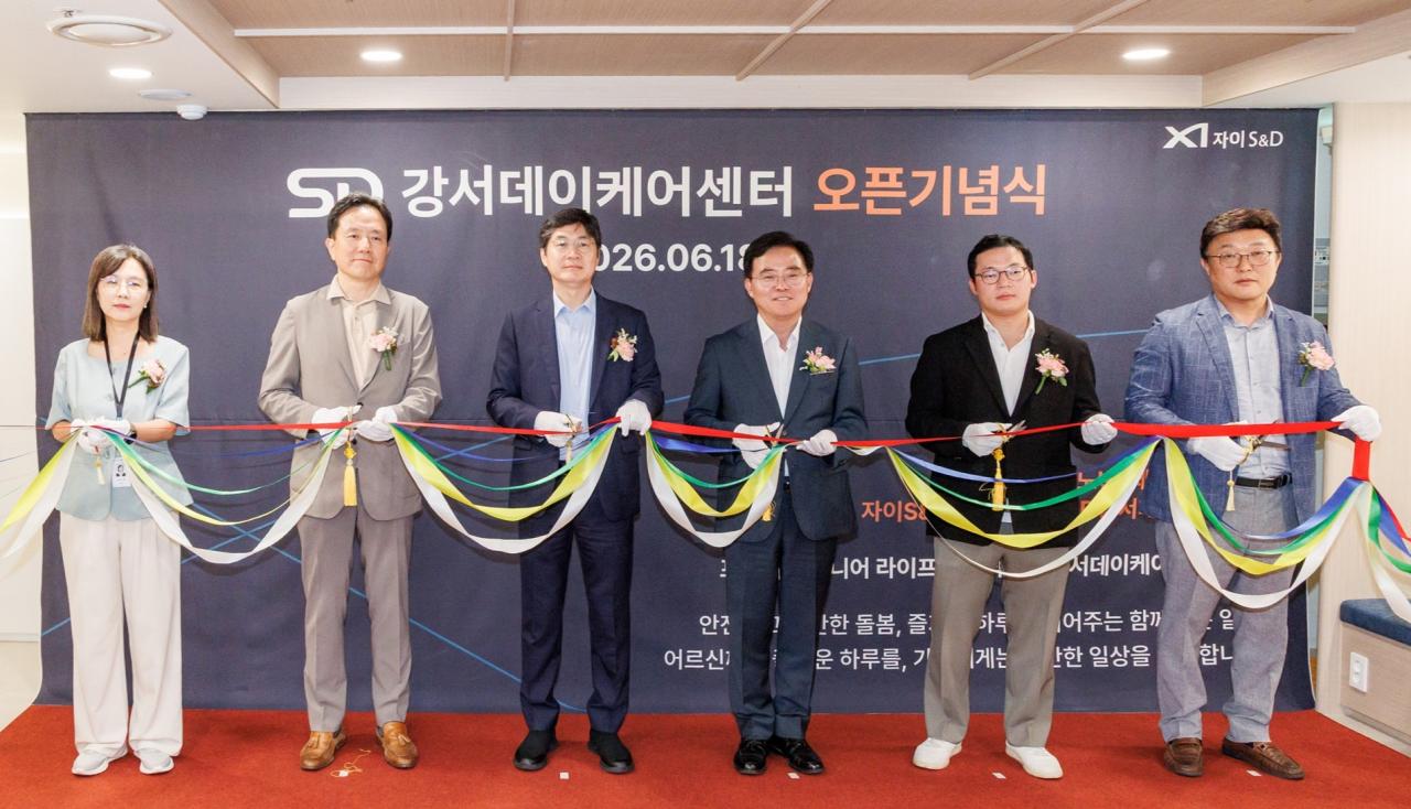 -진교훈 강서구청장(왼쪽 네 번째)이 18일 ‘SD강서데이케어센터 개소식’에서 구본삼 자이S&D 대표이사(왼쪽 세 번째) 등 참석자들과 테이프 커팅을 하고 있다. (사진 =