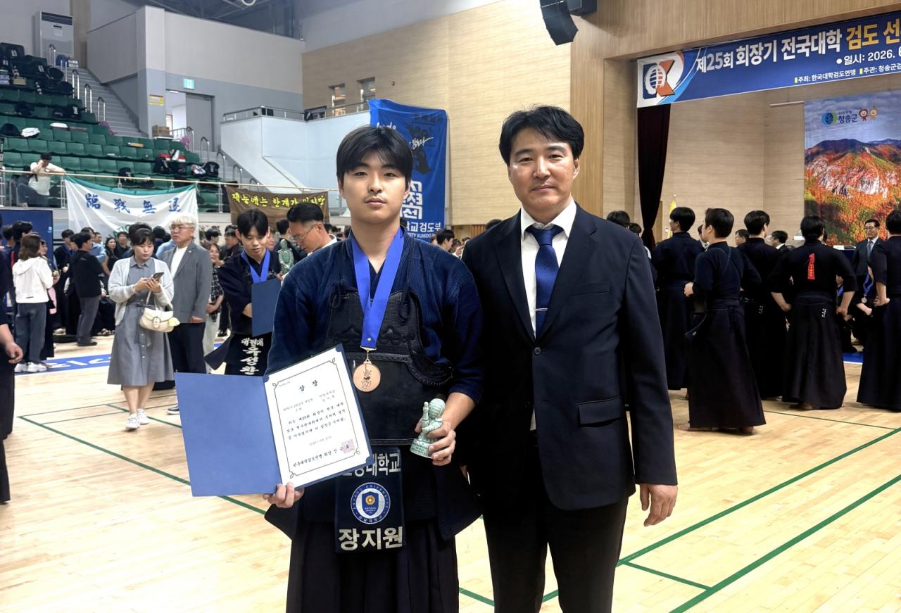 -염종길 안양대 검도부 감독(오른쪽)이 스포츠과학과 장지원 학생과 사진촬영을 하고 있다. (사진 = 안양대학교)