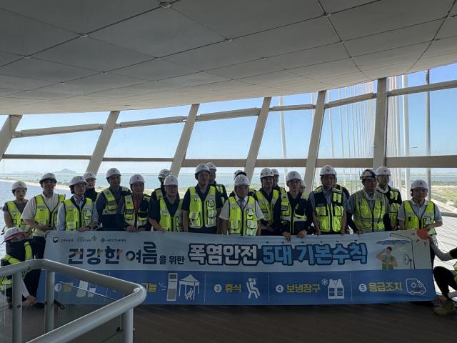 -국토안전관리원이 7월 24일 전북 부안군 새만금동진대교 현장에서 노사 합동 폭염대응 캠페인을 실시하고 단체 기념촬영을 하고 있다. (사진 = 국토안전관리원)