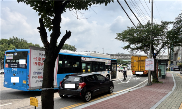 불법 주·정차 차량으로 인해 차로에서 승객이 승차하는 모습. (사진 = 경기도)