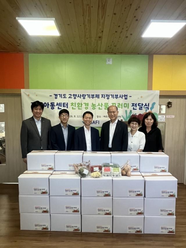 여주지역아동센터에서 열린 ‘고향사랑기부금 활용 친환경 농산물 꾸러미 전달식’에서 경기도농수산진흥원장과 경기도 자치행정국장 등 관계자들이 전달에 앞서 기념촬영을 하고 있다. (사진